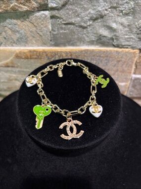 Gold-Tone Charm Bracelet with Green Key and White Logo hearts
